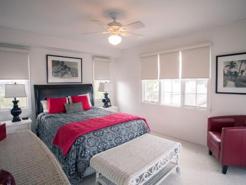 a bedroom with a bed and a ceiling fan at Large Ocean Side Home With Beautiful Views in Loveladies