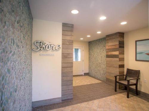 a lobby with a chair and a sign on a wall at Large Ocean Side Home With Beautiful Views in Loveladies