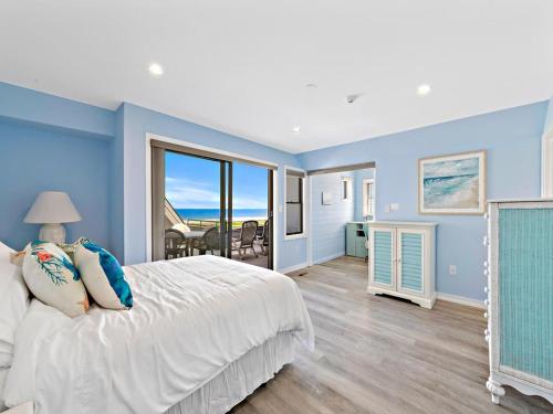 a bedroom with blue walls and a bed with a window at 2 Bedroom 2 Bath 3Rd Floor Fishery Condo With Fabulous Ocean Views in Ship Bottom