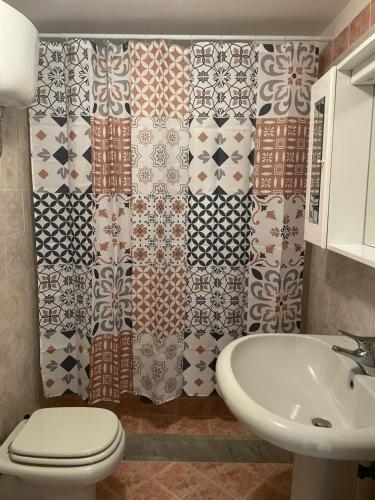 a bathroom with a toilet and a sink at da zia Emanuela in Ottaviano