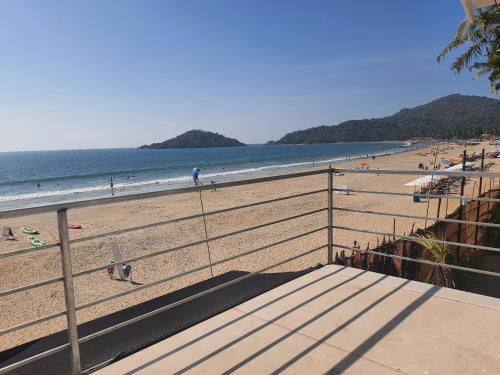 a beach with people on the sand and the ocean at Palolem Beach View Inn in Palolem