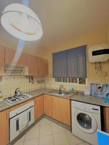 a kitchen with a washing machine and a dishwasher at JIH SAKN in Agadir