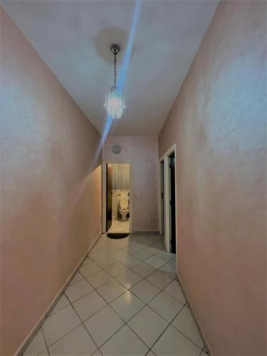 un pasillo vacío con una lámpara de araña en el techo en JIH SAKN en Agadir