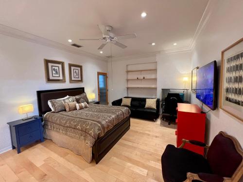 a large bedroom with a bed and a couch at The Signature Orange Grove Suite in Lake Alfred