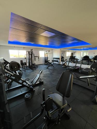 a gym with a lot of treadmills and machines at Studio Moderno Westfit in Mossoró
