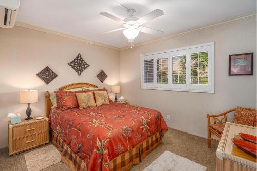 a bedroom with a bed and a ceiling fan at Maalaea Kai 311 - Direct Ocean Front, Split AC in Wailuku
