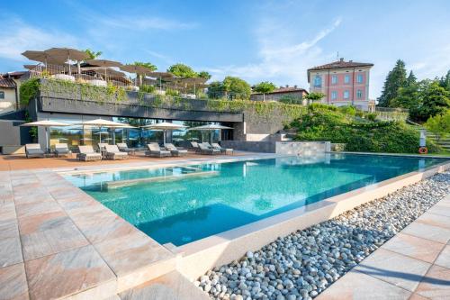 a swimming pool with a bridge over it at Relais & Spa Castello di Casiglio in Erba