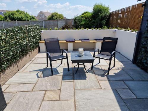 a patio with two chairs and a table at Seabreeze The Annexe in Blackpool
