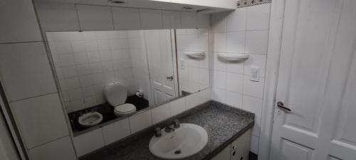 a bathroom with a sink and a toilet at Maui Hostel in Mar del Plata