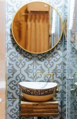 a bathroom with a sink and a mirror at Hebi house in ‘Akko