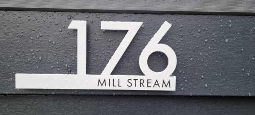 a white sign on the side of a wall at Chalet 176 Glan Gwna Park Caernarfon in Caeathro