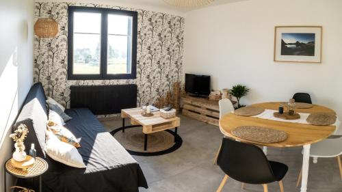 a living room with a table and a dining room at Au cœur des Pyrénées bigourdane in Lau-Balagnas