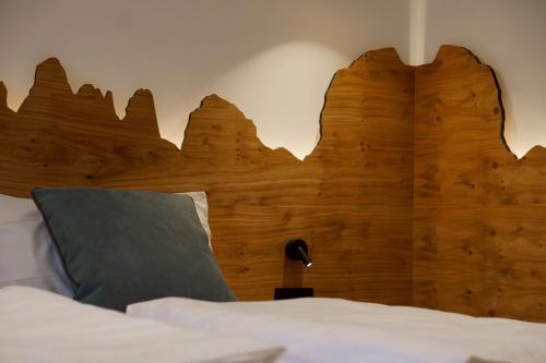 a wooden headboard of a bed in a room at Chalet Larix Andalo Deluxe Apartments in Andalo