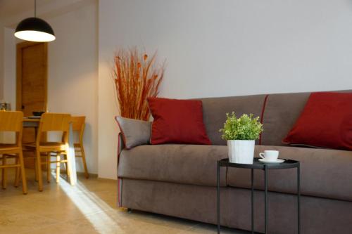 a living room with a couch and a table at Chalet Larix Andalo Deluxe Apartments in Andalo