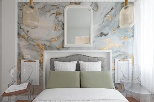 a bedroom with a bed with a mirror and two tables at Le Sapphire in Toulouse