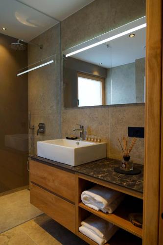 a bathroom with a sink and a mirror at Chalet Larix Andalo Deluxe Apartments in Andalo