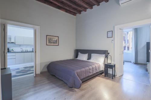a bedroom with a bed in a white room at Prefetti 46 in Rome