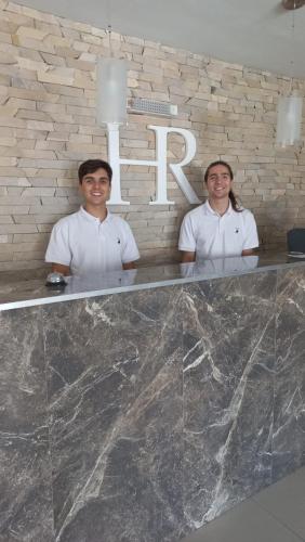 two chefs standing in front of a counter with the letter r at Hotel Rivamar in Mar del Plata