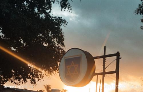 a street light with the sunset in the background at Pousada Estrela de Davi in Penha