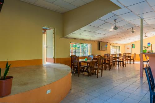 a dining room with a table and chairs at Hotel El Cocobolo Food&Rest Room 4 B&B WiFi AC Pkg Free Swimmingpool in Liberia