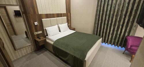 Postel nebo postele na pokoji v ubytování Mardy Suit Hotel