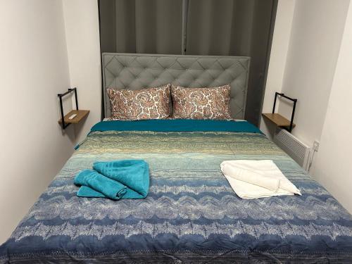 a bedroom with a bed with two towels on it at De Lux Nedeljkovic President in Jagodina