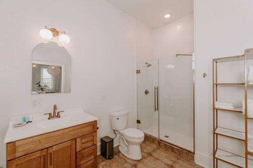 a bathroom with a toilet sink and a shower at East Main Lofts - Coastal 201 in Madison