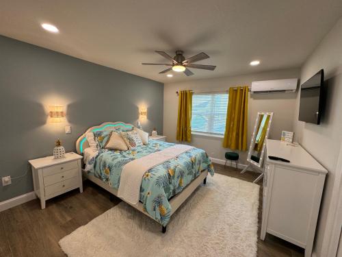 a bedroom with a bed and a ceiling fan at The Wildflower in Siesta Key