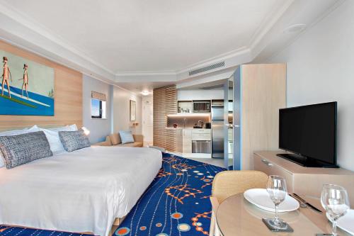 a hotel room with a large bed and a flat screen tv at Marriott Vacation Club at Surfers Paradise in Gold Coast