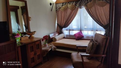 a room with a window with a bed and a mirror at Villa Dalam Laut 580 in Pantai Cenang