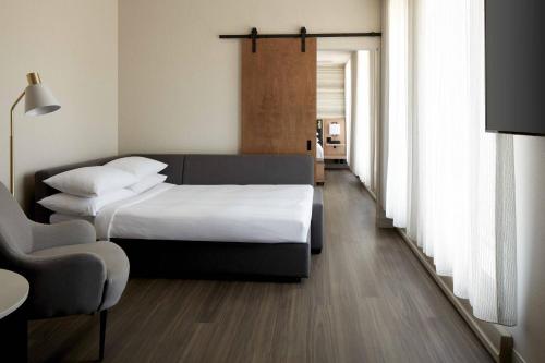 a hotel room with two beds and a chair at Marriott Quebec City Downtown in Quebec City