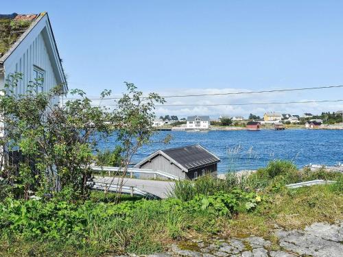 a boat parked next to a house next to a body of water at 7 person holiday home in Averøy-By Traum in Averoy