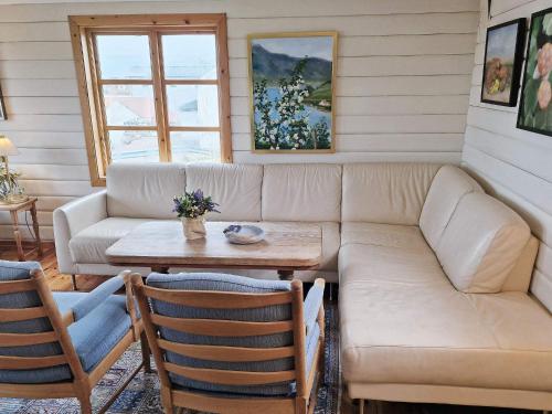 a living room with a couch and a table at 7 person holiday home in Averøy-By Traum in Averoy