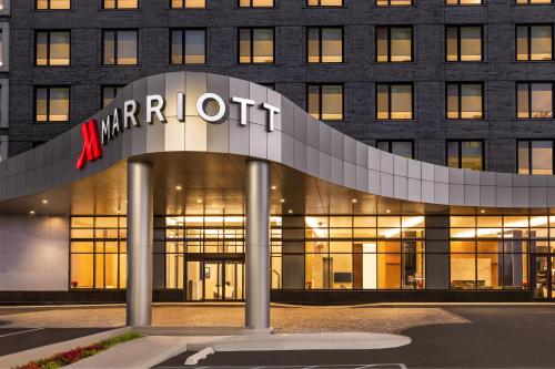 a building with a marriott sign in front of it at Marriott New York JFK Airport in Queens