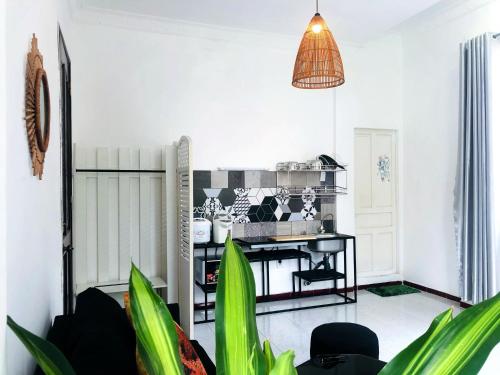 a living room with a table and some plants at Gem Villa 67, biệt thự 15 phòng có hồ bơi lớn in Ho Chi Minh City