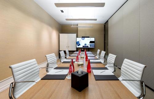a conference room with a long table and white chairs at InterContinental Genève by IHG in Geneva