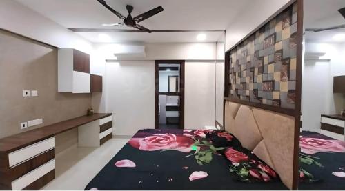 a bedroom with a bed with flowers on it at City Beautiful Home Double Room Suite in Panchkula