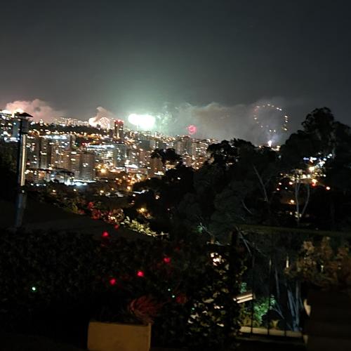 a view of a city at night with fireworks at Posada Verde Natura in Viña del Mar