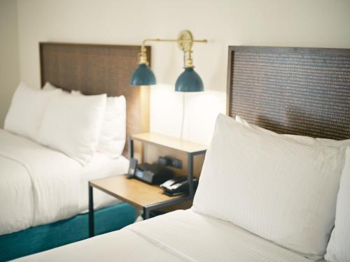 a hotel room with two beds and a table with a phone at SoMa House in San Francisco