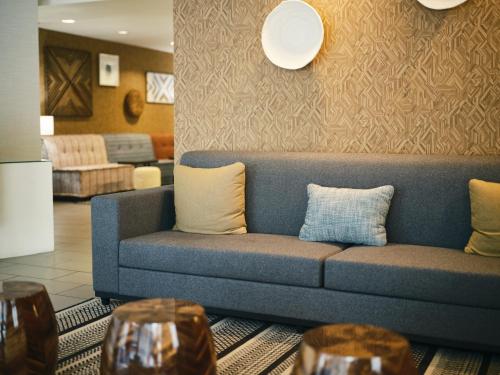 a living room with a blue couch and two tables at SoMa House in San Francisco