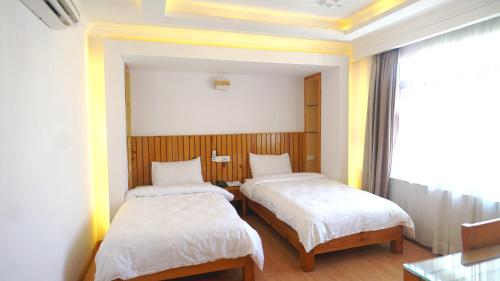 a room with two beds and a window at Kathmandu Height Boutique Hotel in Kathmandu