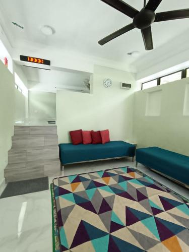 a living room with a couch and a colorful rug at Dango1881muslim riverstay in Padang Rengas
