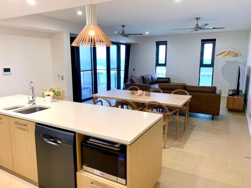 a kitchen and living room with a table and a dining room at Serenity Blue Waters - 3 bedrooms on 8th floor at Darwin Waterfront in Darwin