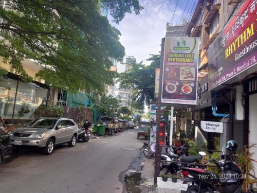 a street with motorcycles parked on the side of the road at Rhythm Bollywood Guesthouse in Phnom Penh