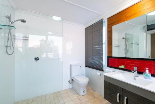 a bathroom with a toilet and a shower and a sink at 170Keppel Plantation House Bathurst in Bathurst