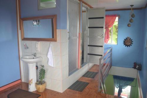 a bathroom with a sink and a shower and a stairway at BANAUE EVERGREEN HOSTEL AND RESTAURANT in Banaue