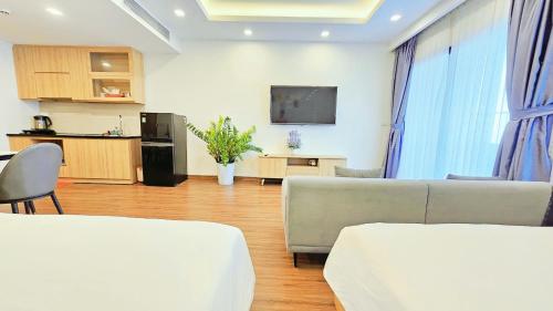 a living room with two couches and a flat screen tv at FLC SEA TOWER QUY NHƠN ban công, bồn tắm, hồ bơi có phí, sát biển in Quy Nhon