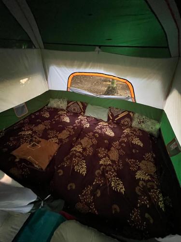 a bed in the back of a tent at Dragster Tents in Kizhake Chālakudi