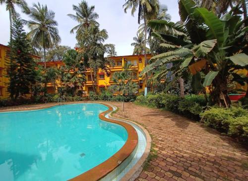 a swimming pool in front of a resort at Calangute apartment in Calangute