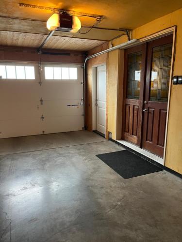 an empty garage with two doors and a concrete floor at Nature's Nook in Victoria